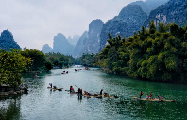 See bamboo rafts, layered karst peaks and open farmland from Yangshuo Gongnong Bridge