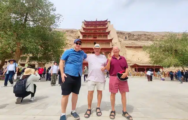mogao caves in dunhuang with travelers
