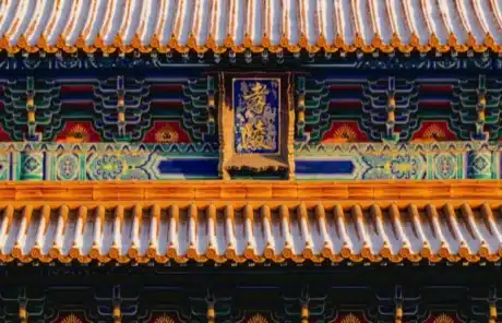 ming-xiaoling-mausoleum - China Xian Tour: Private & Tailor-Made China Tours Close-up of a traditional Chinese temple roof with orange ceramic tiles and a central blue plaque with gold characters.
