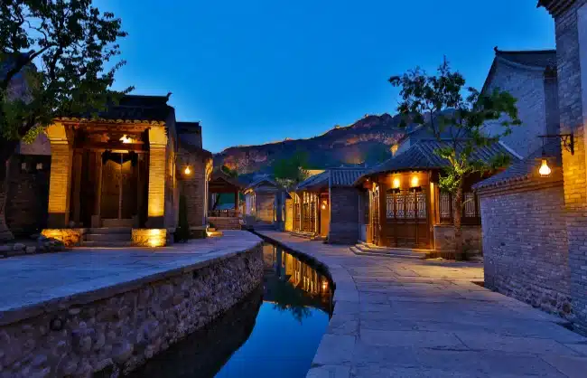 gubei water town | China Xian Tour: Private & Tailor-Made China Tours Beijing Gubei Water Town night view with traditional Chinese architecture and a stream.