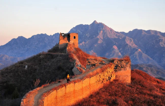 panlongshan great wall in gubeikou great wall | China Xian Tour: Private & Tailor-Made China Tours Sunset-lit Panlongshan Great Wall winding over a hill with distant mountains in view.
