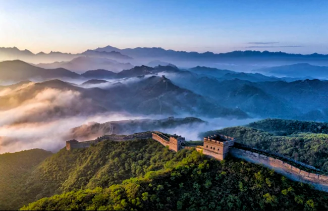 surrounding scenery in gubeikou great wall | China Xian Tour: Private & Tailor-Made China Tours Sunrise and sea od cloud over the Guebeikou Great Wall winding through green mountains.