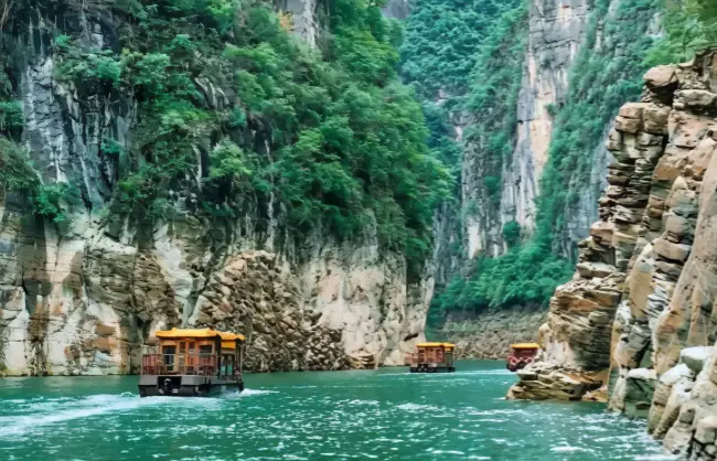 Scenic cruise boats at green Shennv Stream