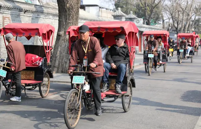 Hop into a rickshaw through the labyrinth of hutong alleys