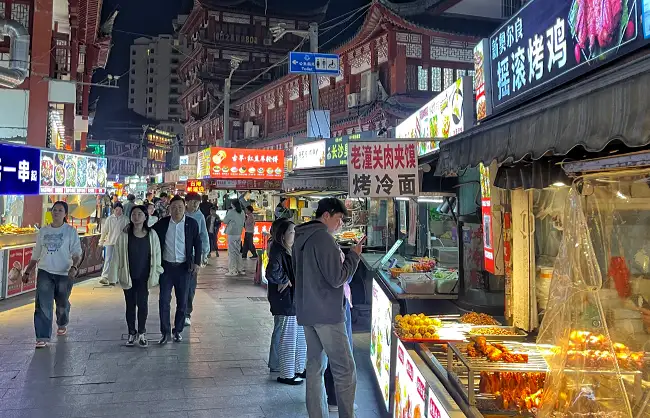 zhoupu-little-shanghai-pedestrian-street-night-market | China Xian Tour: Private & Tailor-Made China Tours Tasting snacks at Zhoupu night market